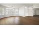 Spacious living room with wood floors, arched windows, and modern white shutters at 18873 N 94Th Way, Scottsdale, AZ 85255