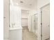 Modern bathroom with double vanity, glass shower, and walk-in closet at 19406 N Fiano Dr, Maricopa, AZ 85138