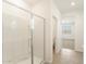 Bathroom with a walk-in shower with glass door and a view into an additional powder room at 19406 N Fiano Dr, Maricopa, AZ 85138