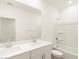Modern bathroom featuring a double sink vanity, large mirror, and a combined shower and tub at 19406 N Fiano Dr, Maricopa, AZ 85138