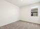 Comfortable carpeted bedroom with neutral walls, a window and two electrical outlets at 19406 N Fiano Dr, Maricopa, AZ 85138