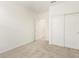 Bedroom featuring neutral carpet, white walls, closet and doorway, and ample natural light at 19406 N Fiano Dr, Maricopa, AZ 85138