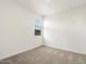Bright, carpeted bedroom with neutral walls, a window and an electrical outlet at 19406 N Fiano Dr, Maricopa, AZ 85138