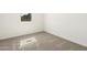 Cozy bedroom with neutral carpet, white walls, and a window offering natural light at 19406 N Fiano Dr, Maricopa, AZ 85138