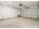 Spacious two-car garage with smooth concrete floor and an insulated steel garage door at 19406 N Fiano Dr, Maricopa, AZ 85138