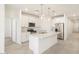 Modern kitchen with a large island, stainless steel appliances, and white cabinetry at 19406 N Fiano Dr, Maricopa, AZ 85138