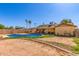 Large backyard featuring a pool, patio, and desert landscaping at 19407 N 15Th Ave, Phoenix, AZ 85027