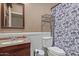 Bathroom featuring single sink vanity and toilet/shower combination at 19407 N 15Th Ave, Phoenix, AZ 85027