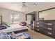 Comfortable bedroom with carpet, ceiling fan, window, television and dresser at 19407 N 15Th Ave, Phoenix, AZ 85027