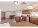 View of kitchen and dining area with tile floors, wood cabinets, and modern appliances at 19407 N 15Th Ave, Phoenix, AZ 85027