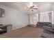 Spacious living room with a tile entryway and two sofas with a ceiling fan at 19407 N 15Th Ave, Phoenix, AZ 85027
