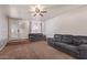Spacious living room with a tile entryway and two sofas with a ceiling fan at 19407 N 15Th Ave, Phoenix, AZ 85027