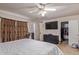Bedroom with large bed, dark furniture, walk-in closet, and mounted television at 19407 N 15Th Ave, Phoenix, AZ 85027