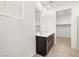 Modern bathroom with double sink vanity and access to walk-in closet at 19438 N Fiano Dr, Maricopa, AZ 85138