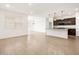 Spacious living space flows into the kitchen, featuring modern finishes and an open concept design for seamless living at 19438 N Fiano Dr, Maricopa, AZ 85138