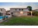 Expansive backyard with a sparkling pool, patio area, and verdant lawn at 2109 W Wildhorse Dr, Chandler, AZ 85286
