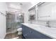 Bathroom features double sinks, gray cabinets, and a shower with stone-look tile at 2109 W Wildhorse Dr, Chandler, AZ 85286