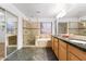 Bathroom features tile, a glass shower, a soaking tub, and a wood cabinet at 2109 W Wildhorse Dr, Chandler, AZ 85286