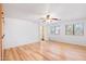 This bright bedroom features hardwood floors, a ceiling fan, and large windows at 2109 W Wildhorse Dr, Chandler, AZ 85286