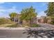 Charming home with a well-manicured lawn, mature trees, and a welcoming facade at 2109 W Wildhorse Dr, Chandler, AZ 85286