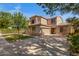 Attractive home with a spacious driveway, landscaped yard, and mature trees at 2109 W Wildhorse Dr, Chandler, AZ 85286