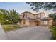 Inviting home featuring a large driveway, well-maintained lawn, and classic architecture at 2109 W Wildhorse Dr, Chandler, AZ 85286