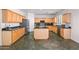 Modern kitchen with an island, wood cabinets, stainless steel appliances, and ample counter space at 2109 W Wildhorse Dr, Chandler, AZ 85286