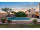 Backyard pool and spa are surrounded by a brick wall and landscaping at 2109 W Wildhorse Dr, Chandler, AZ 85286