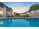 Pool with attached hot tub, surrounded by brick wall and lawn at 2109 W Wildhorse Dr, Chandler, AZ 85286