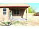 View of the covered back patio with windows, showing the home's rear exterior at 21433 E Calle De Flores Ct, Queen Creek, AZ 85142