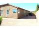 Wide shot of the backyard featuring a gravel ground, windows, and a partial view of a fence at 21433 E Calle De Flores Ct, Queen Creek, AZ 85142