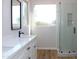 Modern bathroom with white cabinets, quartz counters, and a glass-enclosed shower at 21433 E Calle De Flores Ct, Queen Creek, AZ 85142