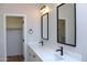 Bathroom featuring double sinks, quartz countertops, black hardware and a closet at 21433 E Calle De Flores Ct, Queen Creek, AZ 85142