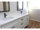 Bathroom featuring double sinks, quartz countertops, and black hardware at 21433 E Calle De Flores Ct, Queen Creek, AZ 85142