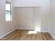 Bedroom featuring wood flooring and a large window with natural light at 21433 E Calle De Flores Ct, Queen Creek, AZ 85142