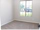 Bright bedroom with neutral carpet, a large window offering a view of the outside, and ample natural light at 21433 E Calle De Flores Ct, Queen Creek, AZ 85142