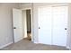 Bedroom featuring carpet, a closet with sliding doors, and view into a hallway with hardwood floors at 21433 E Calle De Flores Ct, Queen Creek, AZ 85142