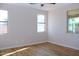 Bedroom with wood flooring and ample natural light from multiple windows at 21433 E Calle De Flores Ct, Queen Creek, AZ 85142