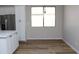 Dining area with wood flooring, a window, and white cabinets at 21433 E Calle De Flores Ct, Queen Creek, AZ 85142