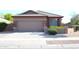 Single-story home featuring a two-car garage and desert landscaping at 21433 E Calle De Flores Ct, Queen Creek, AZ 85142
