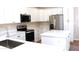 Modern kitchen featuring stainless appliances, white cabinets, and white countertops at 21433 E Calle De Flores Ct, Queen Creek, AZ 85142