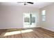 Bright, airy living space featuring modern floors and a sliding glass door to backyard at 21433 E Calle De Flores Ct, Queen Creek, AZ 85142