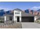 Inviting single-story home featuring a neutral color palette, attached garage, and desert landscaping at 2317 S 125Th Dr, Avondale, AZ 85323