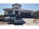 Craftsman style home with stone accents, a two-car garage, and a covered porch under construction at 2317 S 125Th Dr, Avondale, AZ 85323