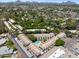Aerial view of multiple townhomes featuring a community pool, mature landscaping, and mountain views at 2946 N 14Th St # 3, Phoenix, AZ 85014