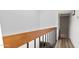 Upstairs hallway with wood railing and wood-look flooring, leading to other rooms at 2946 N 14Th St # 3, Phoenix, AZ 85014
