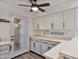 Well-lit kitchen with bright countertops, white cabinets, stainless appliances, and an exterior door at 2946 N 14Th St # 3, Phoenix, AZ 85014