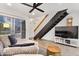 Bright living room features modern ceiling fan, wood floors, and open staircase at 2946 N 14Th St # 3, Phoenix, AZ 85014