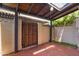 Private patio showcasing secure gate entry, textured walls, and block wall boundaries at 2946 N 14Th St # 3, Phoenix, AZ 85014