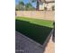 Well-maintained backyard featuring an artificial lawn and charming stone accents at 3064 E Michelle Way, Gilbert, AZ 85234